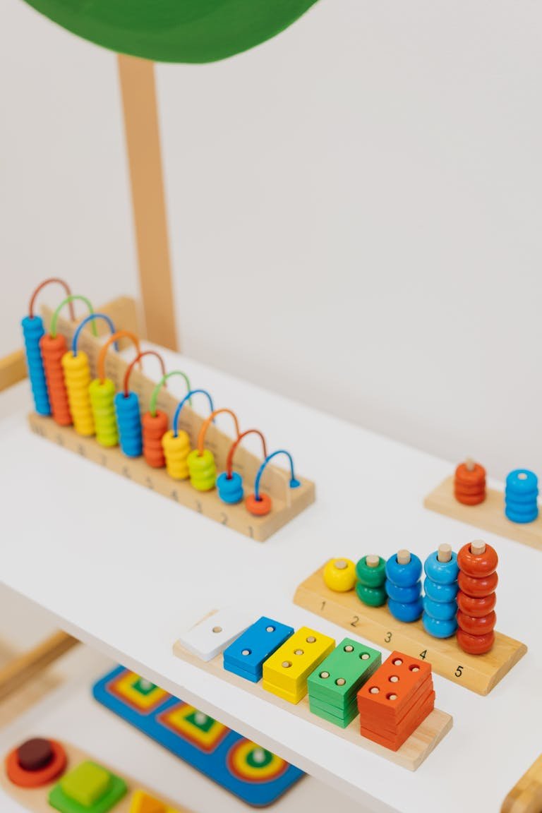 Bright and colorful wooden educational toys displayed on a shelf for learning.